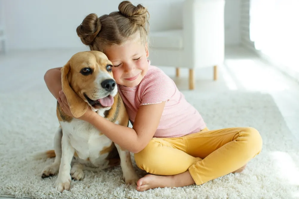 Woman giving her dog a kiss on the nose