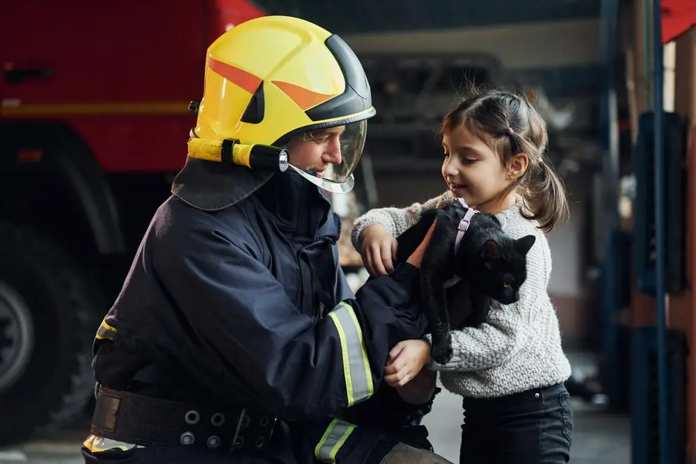 fireman with a child and a dog