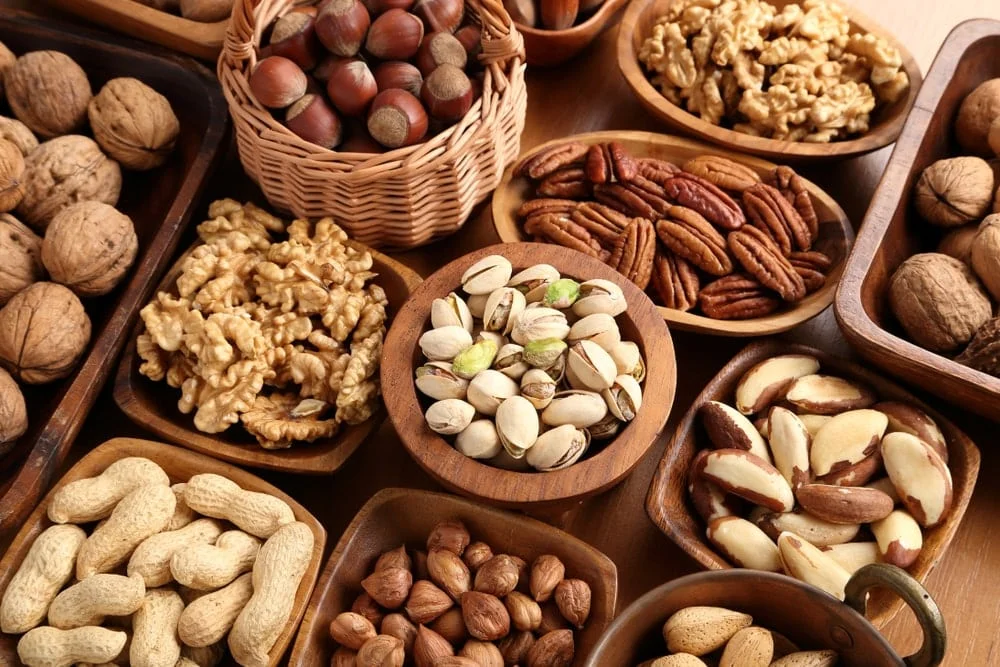 A variety of nuts in wooden bowls. 