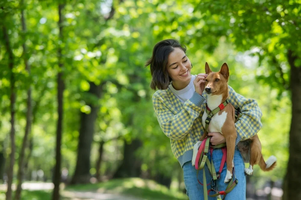 Woman walking in the park with her dog