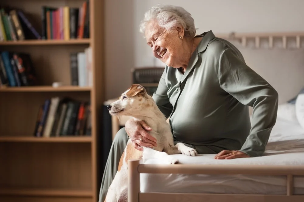 Senior woman enjoying time with her dog on the couch