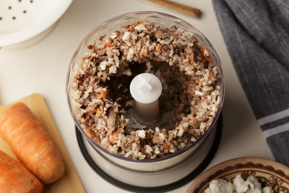 A food processor with ground homemade dog food. 