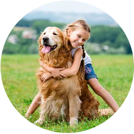 little girl hugging her dog
